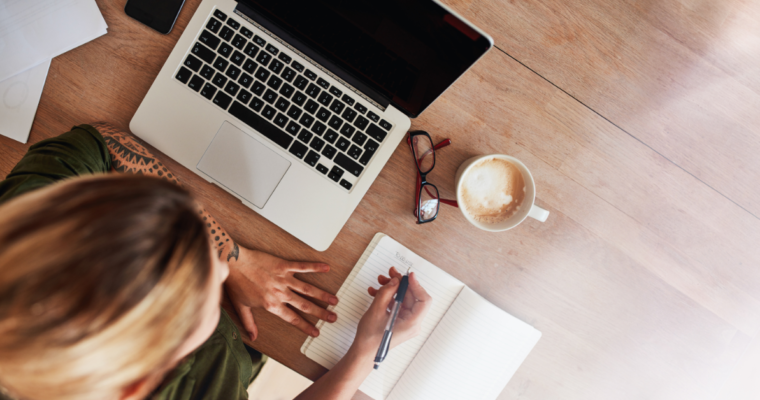 Woman sitting at desk researching best vestibular migraine products.