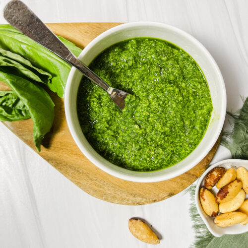 a fresh display of basil pesto with brazil nuts and basil leaves